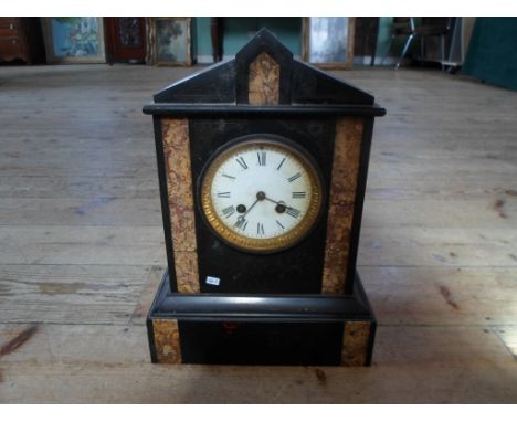 A Victorian black slate and marble mantle clock, the circular enamel dial bearing Roman numerals (34cm tall).