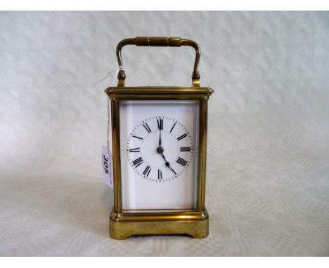 A French gilt brass carriage clock, early 20th century, having five bevel edged glass panels, coil gong striking movement no.