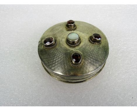 A Continental gem set compact, of circular engine turned form, with gem set hinged cover and European silver marks.   Conditi