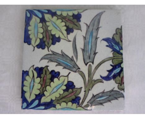 A late 19th century tile, probably William de Morgan, featuring an Islamic inspired design painted in shades of blue and gree