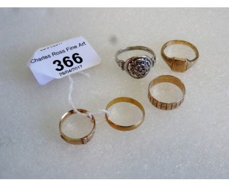 A 22ct gold wedding band, together with two 9ct gold rings, an 18ct gold ring and a silver ring.   Condition Report:  22ct = 