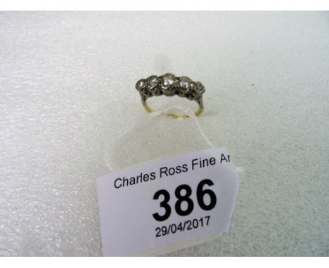 A five stone half-hoop diamond ring, the graduated brilliant cut diamonds in an illusion setting to carved mount.