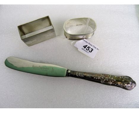 Two silver napkin rings, each with engine turned decoration, together with a boxed silver handled knife.