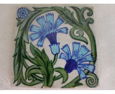 A William de Morgan Carnation pattern tile, painted in shades of blue and green, impressed circular W. de Morgan stamp to rev