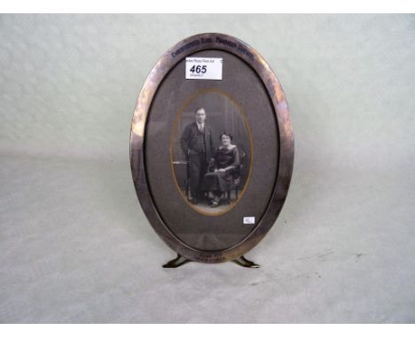 An oval silver easel picture frame, early 20th century, marked 'Sterling' (26cm x 18.2cm).