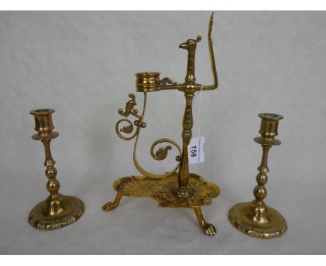 A Victorian brass width adjustable candlestick, formed as a stylized bird, the lower tray on tripod paw feet (28cm), together