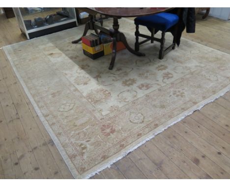 A Zeigler style carpet in cream and stylised faded colours, 294cm x 244cm