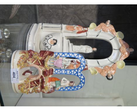 A Victorian Staffordshire figure group of a couple standing over a boat passing through an arch 10cm high, and another of the