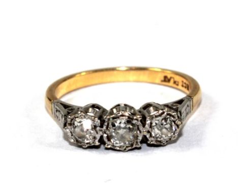 An 18 carat gold ring set with three old cut diamonds