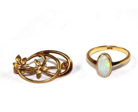 An 18 carat gold ring set with an oval opal and a rolled gold small brooch made in Germany