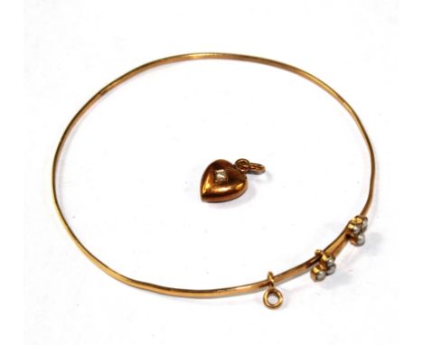 An unmarked pearl set bangle