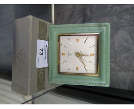 A Cyma Amic green leather table clock, Sonomatic, in green leather case and original box, 8.5cm square