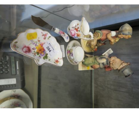 A W. Goebel Hummel figure of a girl feeding chickens, 14cm high and another of two boys singing, a miniature tea cup and sauc