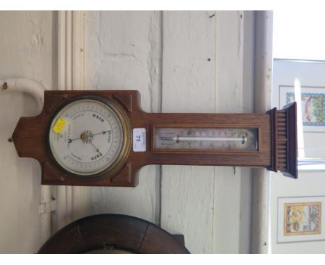 An oak framed Negretti and Zambra aneroid barometer and mercury thermometer, no. R/10820 47cm high