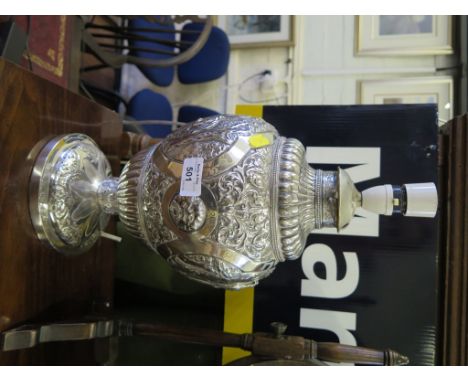 A Victorian silver table lamp, the gadrooned bulbous body depicting scenes from Hamlet with central shield cartouche, on pede