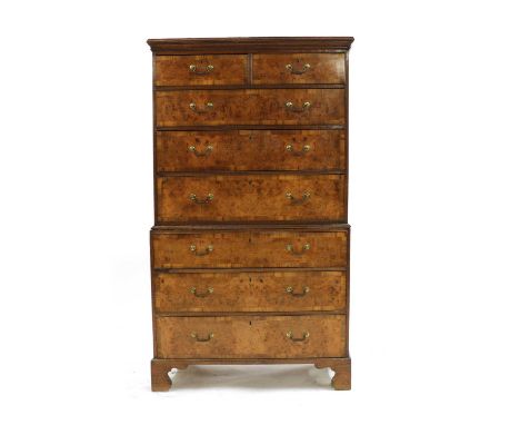 A George III oak and walnut chest on chest, the moulded cornice above two short and six long drawers, each with later walnut 