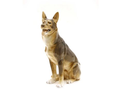 A Copenhagen porcelain model of an Alsatian, two Ostrich eggs and one other, a Puffer fish, an African carving of a tribesman