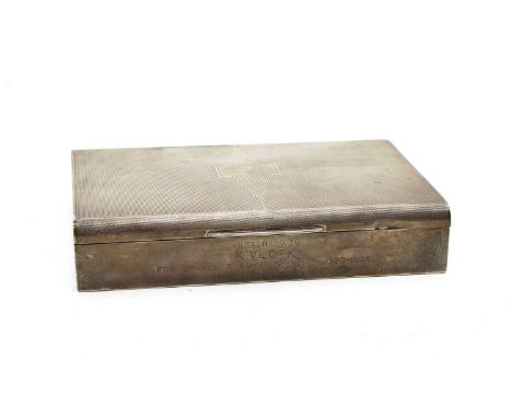 A silver cigarette box, low rectangular form, engine turned decoration and inscribed '20 years of loyal service', Birmingham 