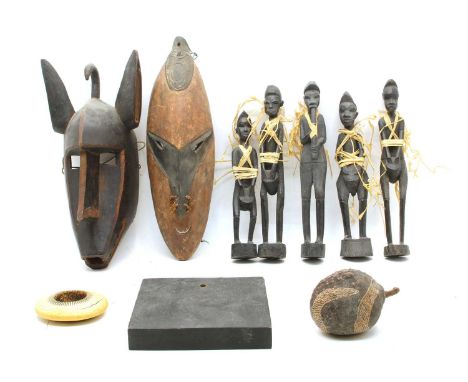 A collection of tribal items, two masks, a bangle and carved figures, largest 45cm
