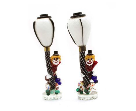 A pair of Murano glass clown lamps, modelled as clowns sitting at the bases of lampposts, 34cm highCondition report: Surface 