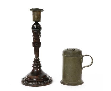 A lignum vitae turned candlestick, with a metal sconce, 26cm high and a tin flour dredger and cover, 19th century, 12cm highC