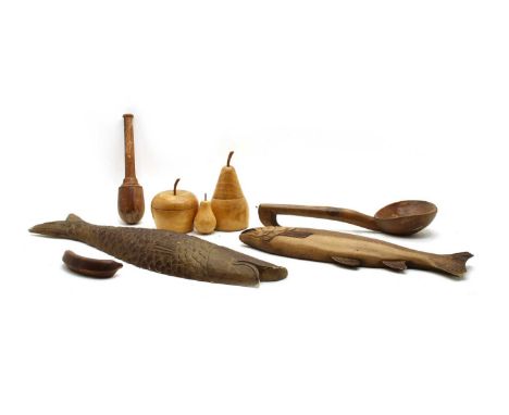 A collection of treen items, to include two boxes in the form of a pear and an apple, two model fish and a collection of kitc