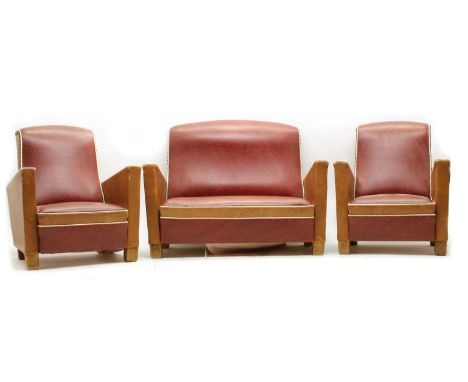 A miniature Art Deco three-piece suite, red/brown leatherette with white piping, settee 33cm high x 46cm wide (3)Condition re
