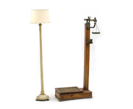 An Edwardian oak set of scales, by Avery & Co, complete with set of weights, 153cm high, and a white painted standard lamp, 1
