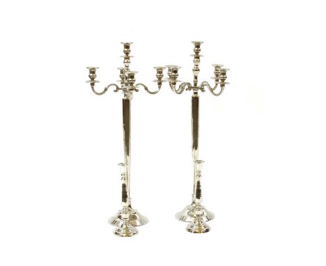 A pair of modern floor standing polished aluminium four light candelabra, 43cm wide x 101cm high and a pair of table candlest