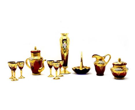 A collection of Czechoslovakian glass, including a liqueur decanter in red with gold overlay, six glasses and a pair of match