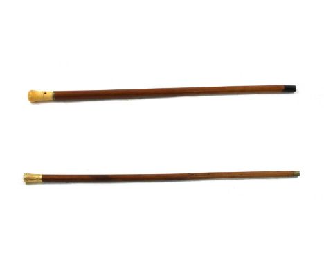 Two Georgian walking sticks, both with malacca shafts, the first with turned ivory handle and strap hole. 94cm long, the seco