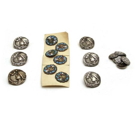 Two sets of Art Nouveau buttons, comprising a French enamel set depicting a winged figure and a white metal set depicting a l