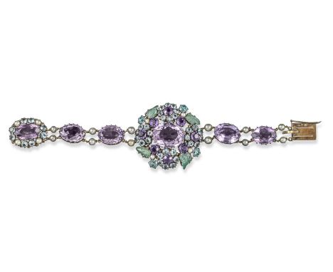 An Arts and Crafts gem-set bracelet attributed to Dorrie Nossiter. The centre cluster is set with an oval-shaped amethyst, fu