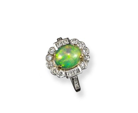 An opal and diamond cluster ring, the oval opal cabochon is set within a surround of circular and princess-cut diamonds in wh