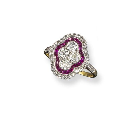 A ruby and diamond cluster ring, the four brilliant-cut diamonds are set in a quatrefoil design within a surround of calibré-