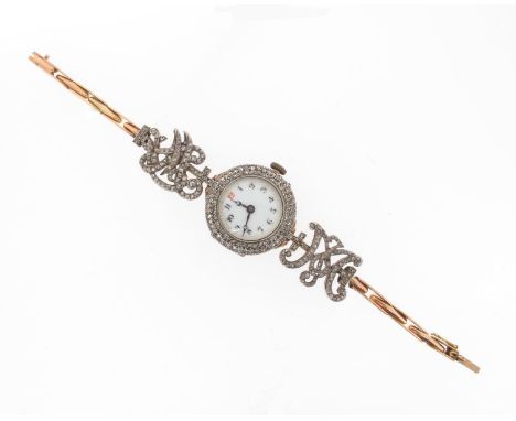 A lady's diamond-set gold wristwatch, the circular dial with Arabic numerals and diamond bezel. The band partially formed fro