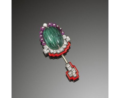 An Art Deco emerald, diamond and ruby jabot pin by Cartier, 1930s. Centred with a carved fluted emerald to the upper section 