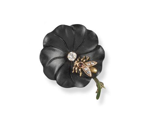 An early 20th century carved black onyx flowerhead brooch, naturalistically formed and centred with an old circular-cut diamo