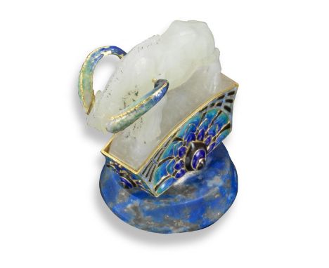 A hardstone desk seal by Boucheron, formed as a carved jade ram with gold enamel horn, on top of a gold and enamel plinth. Wi