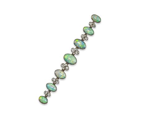 An opal and diamond brooch, alternately set with solid white opal cabochons and diamond quatrefoils in white gold. 8cm wide.