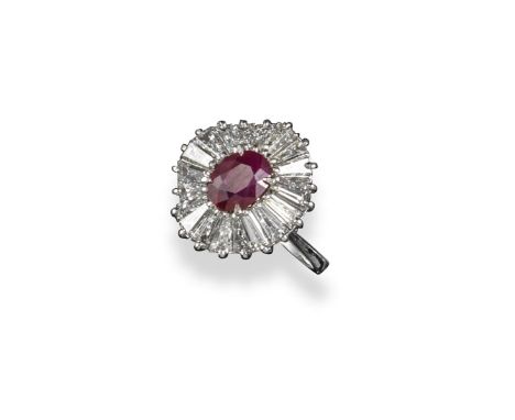 A ruby and diamond set 'ballerina' cluster ring, the oval-shaped ruby is set with an undulating surround of tapered baguette-