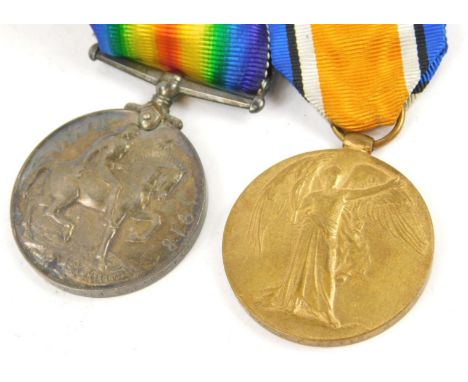 A pair of WWI medals awarded to a Private J E Betts of The Army Service Corp, 1914-18 medal and the Victory medal.