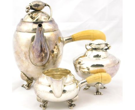 A Georg Jensen sterling breakfast set, decorated in the Magnolia pattern, comprising coffee pot with ivory side handle, cream