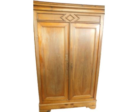 A 19thC French fruitwood armoire, with a moulded cornice, above two panelled doors, on canted bracket feet, 211cm high, 59cm 