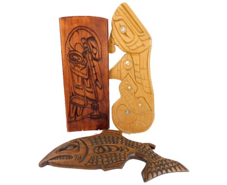 Three American West Coast carvings, one in the form of a fish by Bruce Mickey, another with mother of pearl inlay by Stan K W