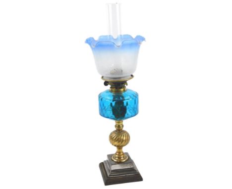 A Victorian steel and iron oil lamp, with a blue reservoir and blue and frosted glass Art Nouveau style shade, 62cm H, the sh