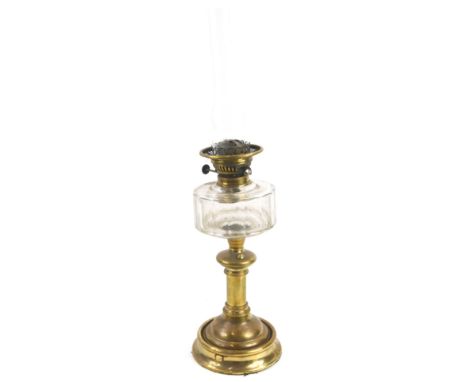 A Victorian style brass oil lamp, with a clear reservoir and chimney, 64cm H.