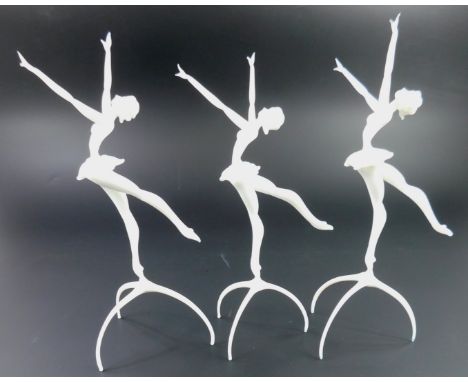 Three unusual Venetian style white opaque glass ballerinas, each on a tripod base, 26cm H.