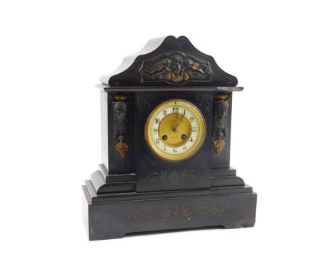 A French black slate and gilt metal mantel clock, decorated with Egyptian style masks, putti etc., the dial stamped J.C Harri