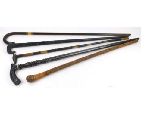 Miscellaneous walking sticks walking canes, to include an ebonised Indian type example with pique work, African ebony carved 